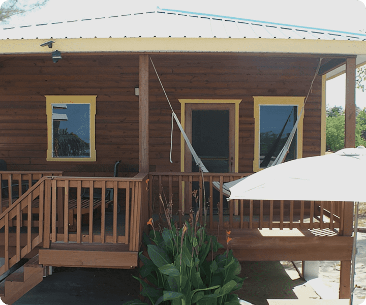 Wooden house with porch and hammock.