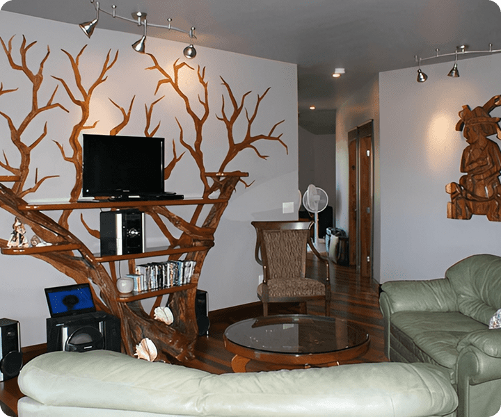 Living room with tree-themed wall decor.
