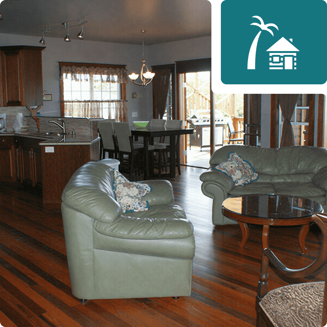 Open-concept living room with green sofas.
