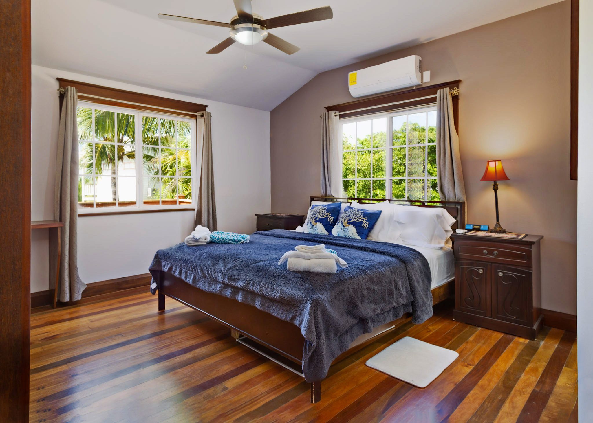 Cozy bedroom with wooden floor and bed.