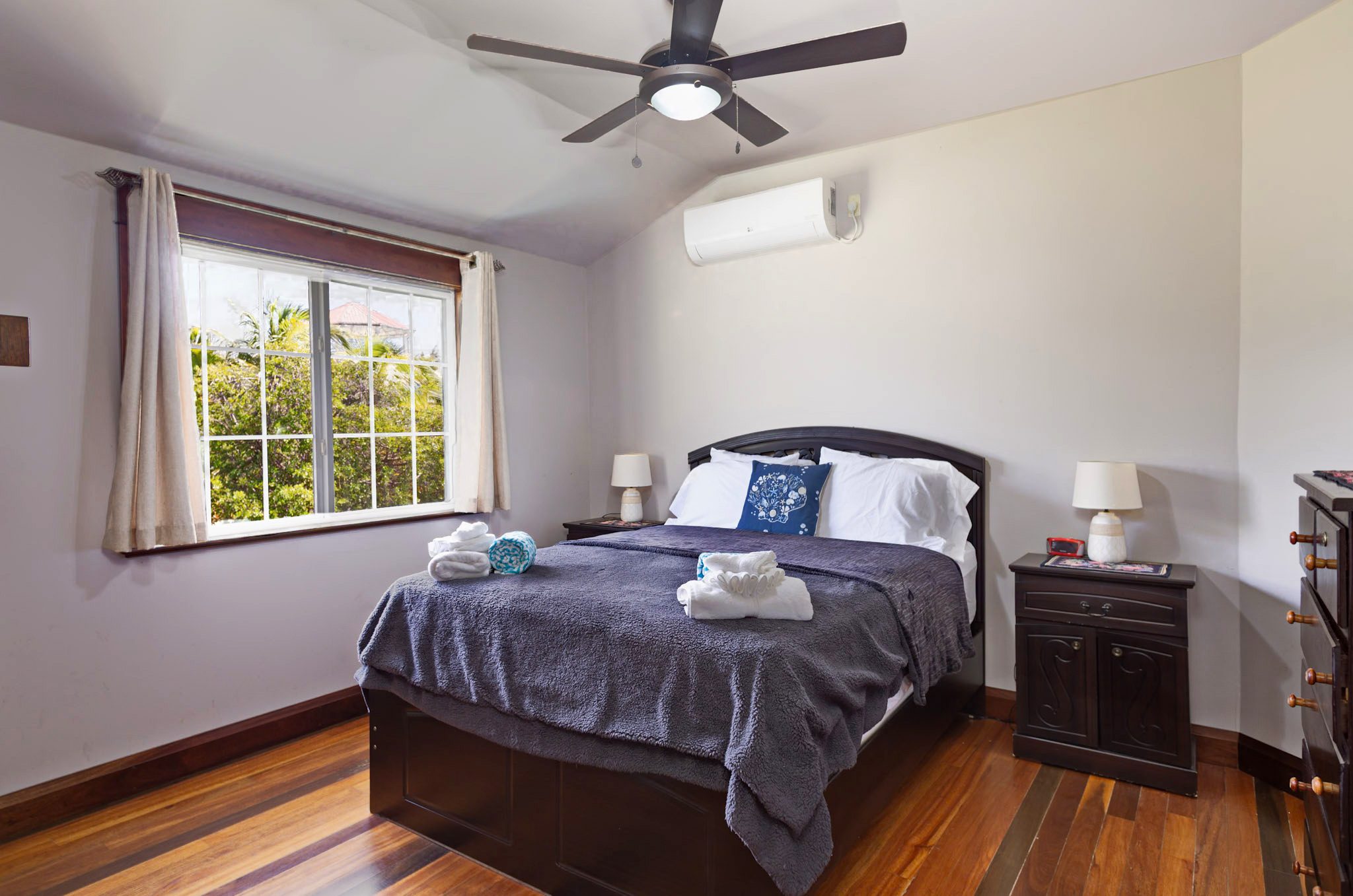 Cozy bedroom with neatly made bed.