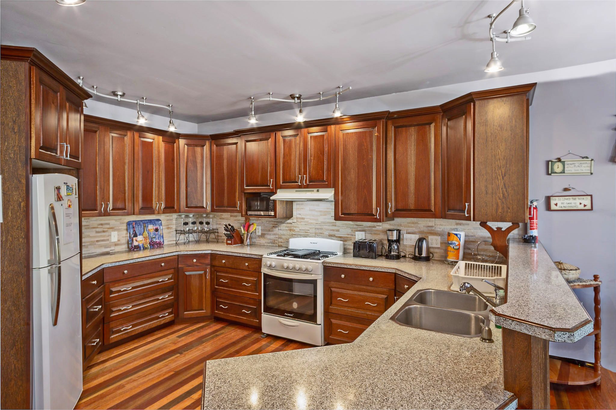 Modern kitchen with wooden cabinets and appliances.